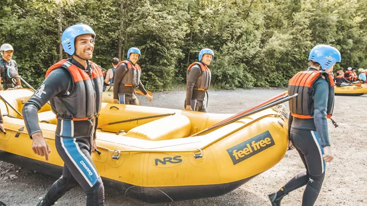 Travellers carrying the raft to the river to start rafting in the Austrian Tyrol, Austria