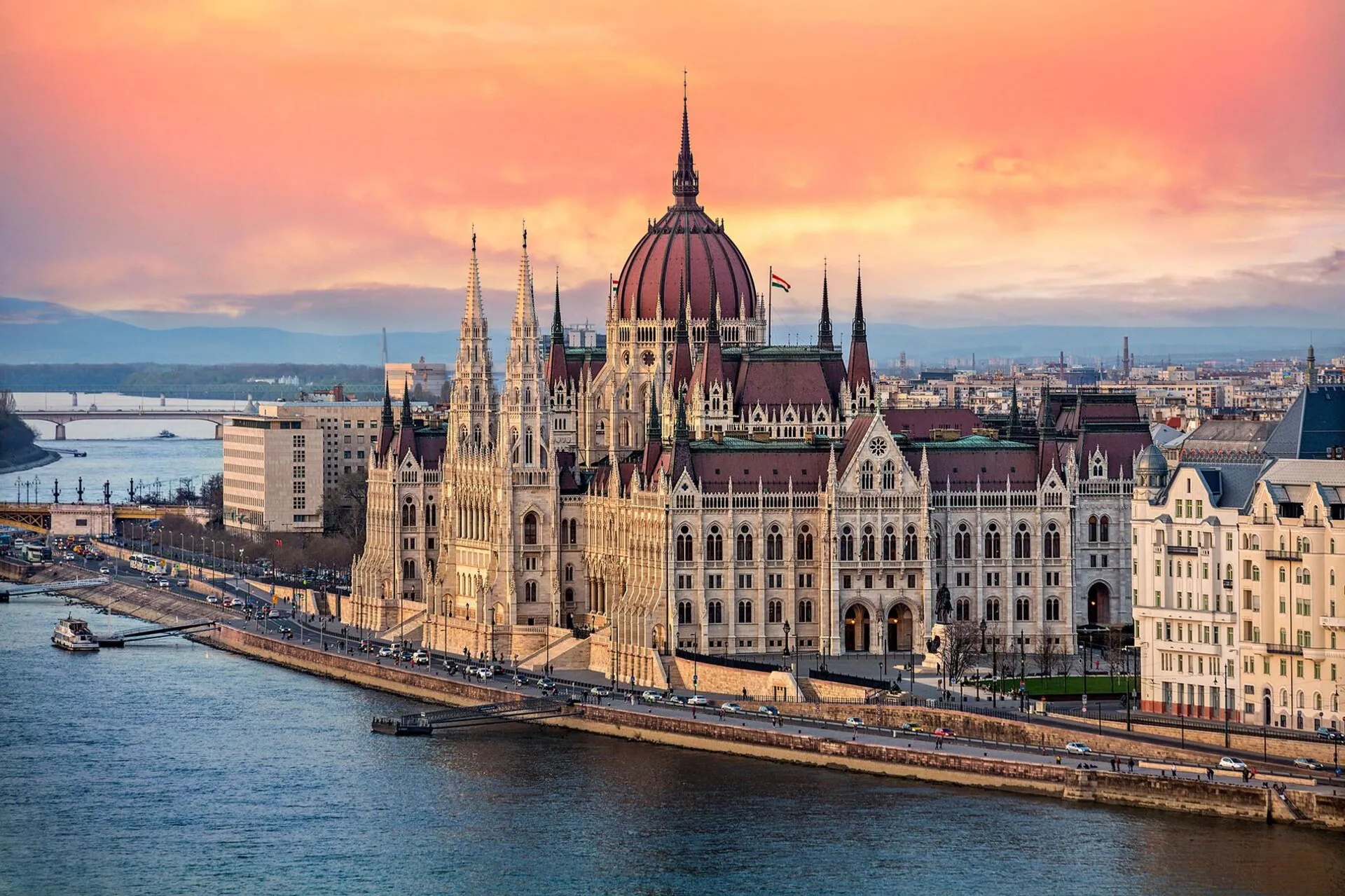 The Hungarian Parliament on the Danube River at sunset in Budapest, Hungary.