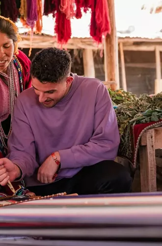 Local artisans demonstrating traditional Andean weaving - Contiki South American Explorer Tour