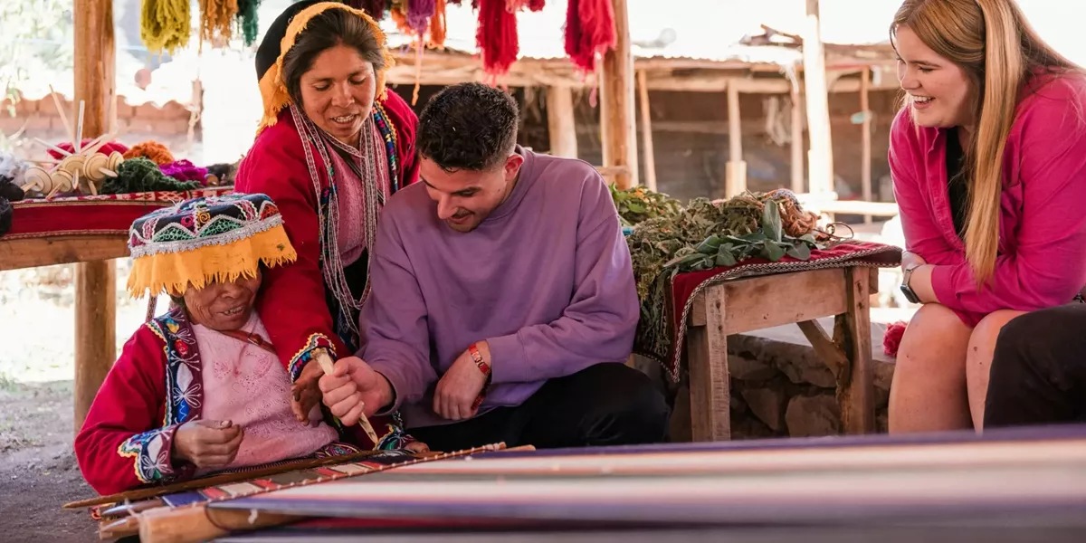 Local artisans demonstrating traditional Andean weaving - Contiki South American Explorer Tour