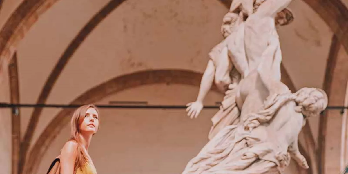 Tourist and ancient sculpture