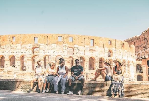 Group of People Sitting in front of Coloseum, Rome