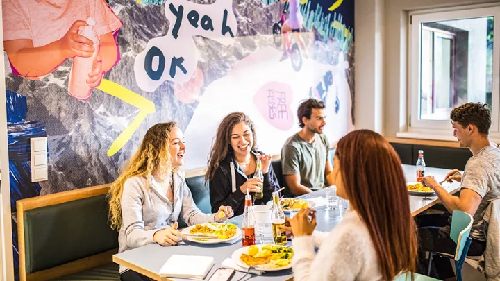 Travellers eating homecooked dinner at Haus Schoneck, Austria-