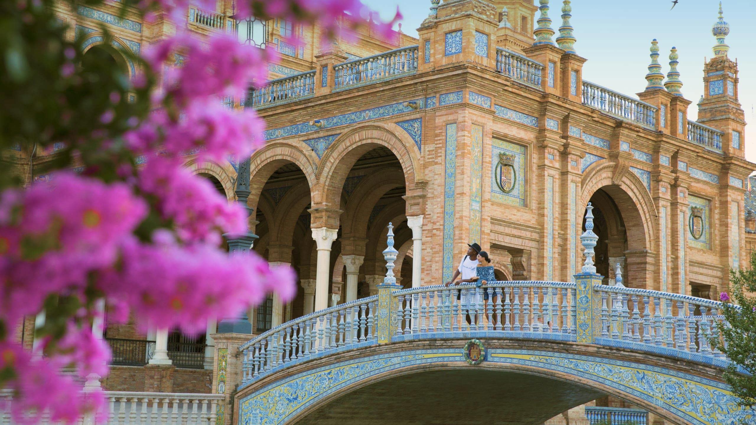 Two people exploring Plaza de España in Seville on Contiki's Madrid to Barcelona Tour in Spain