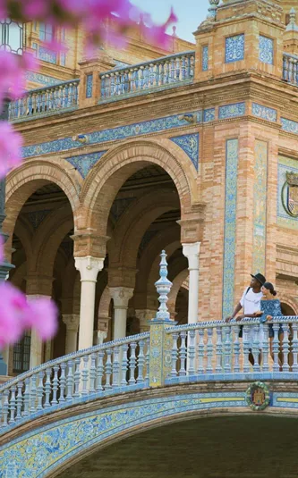 Two people exploring Plaza de España in Seville on Contiki's Madrid to Barcelona Tour in Spain