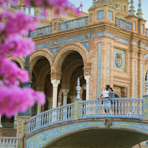 Two people exploring Plaza de España in Seville on Contiki's Madrid to Barcelona Tour in Spain
