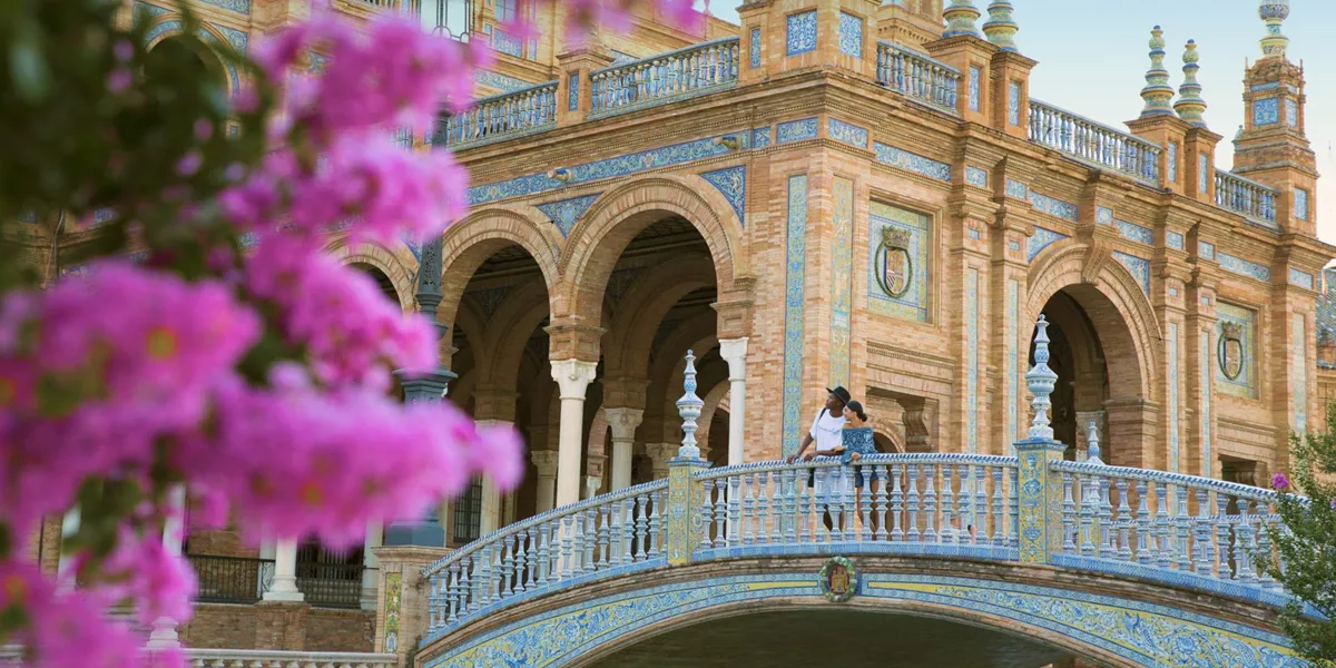 Two people exploring Plaza de España in Seville on Contiki's Madrid to Barcelona Tour in Spain