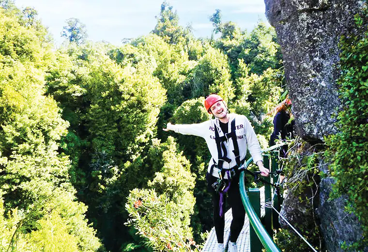Awoman trekking through the UNESCO world heritage listed cape tribulation and Daintree rainforest in Cairns