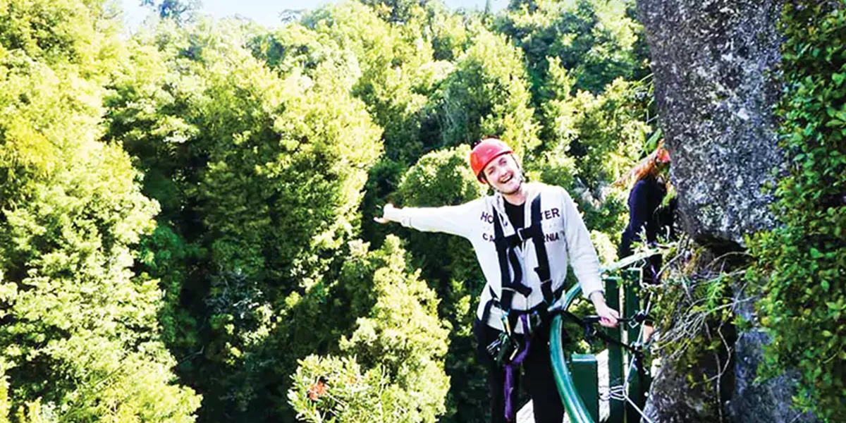 Awoman trekking through the UNESCO world heritage listed cape tribulation and Daintree rainforest in Cairns