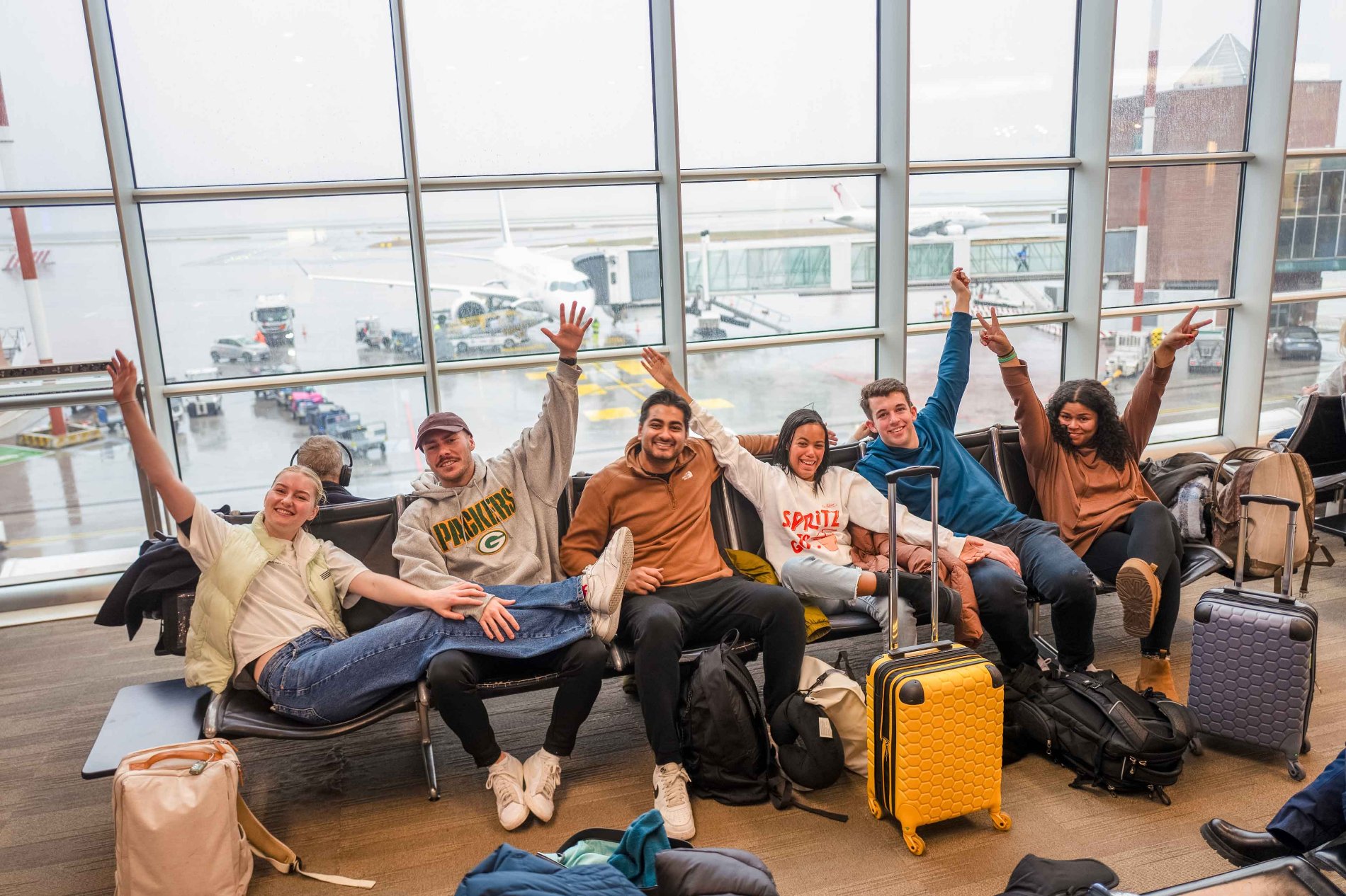 Group Of Young Travelers Waiting at Airport