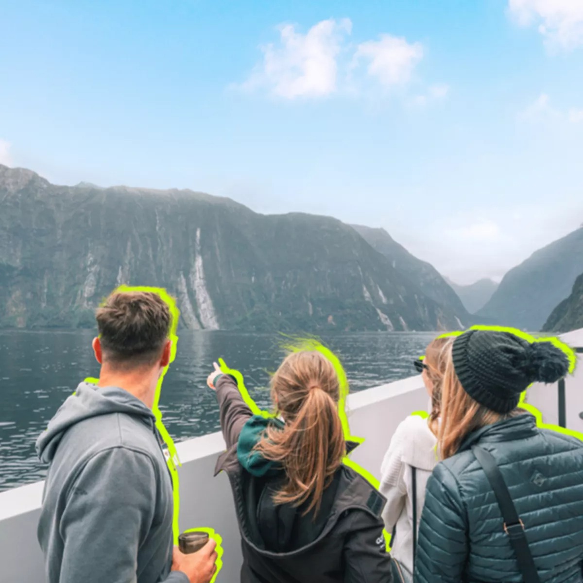 Tourists on a ship looking at cliffs of New Zealand islands
