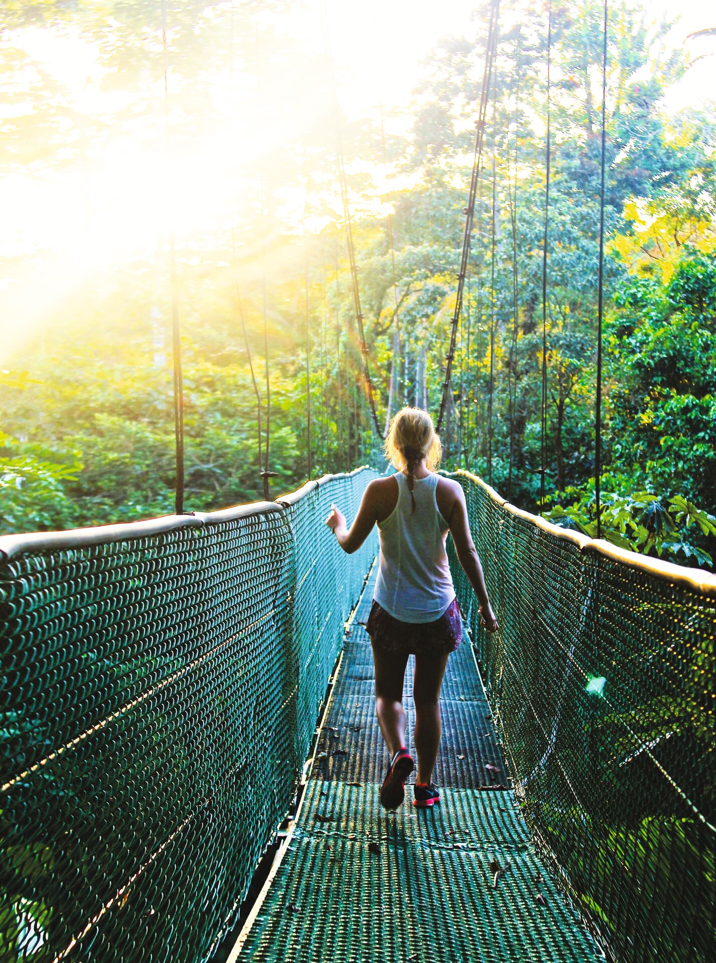 A woman on a rope walking on a bridge