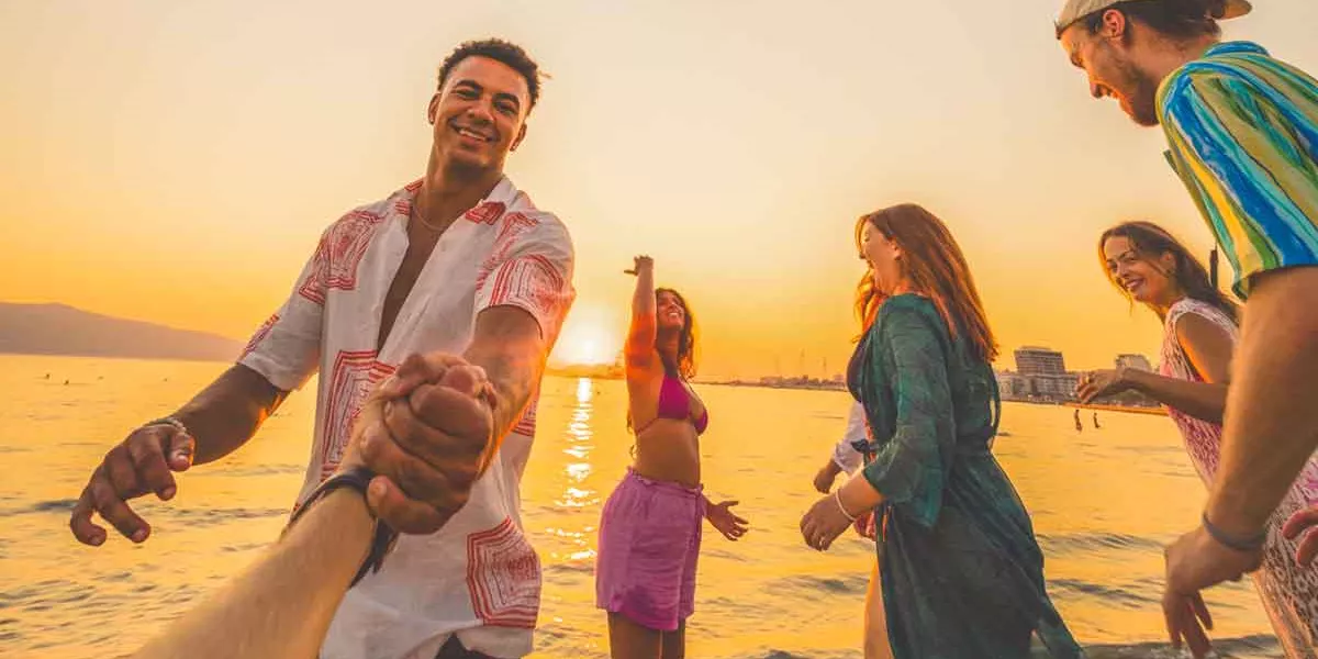 Group Of Young People Playing Vollyball On The Beach