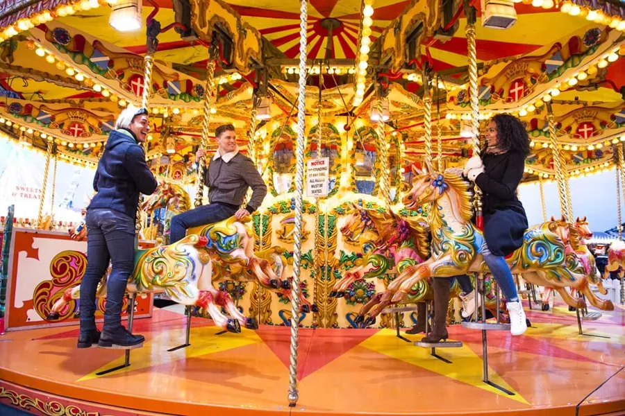 group riding a carousel