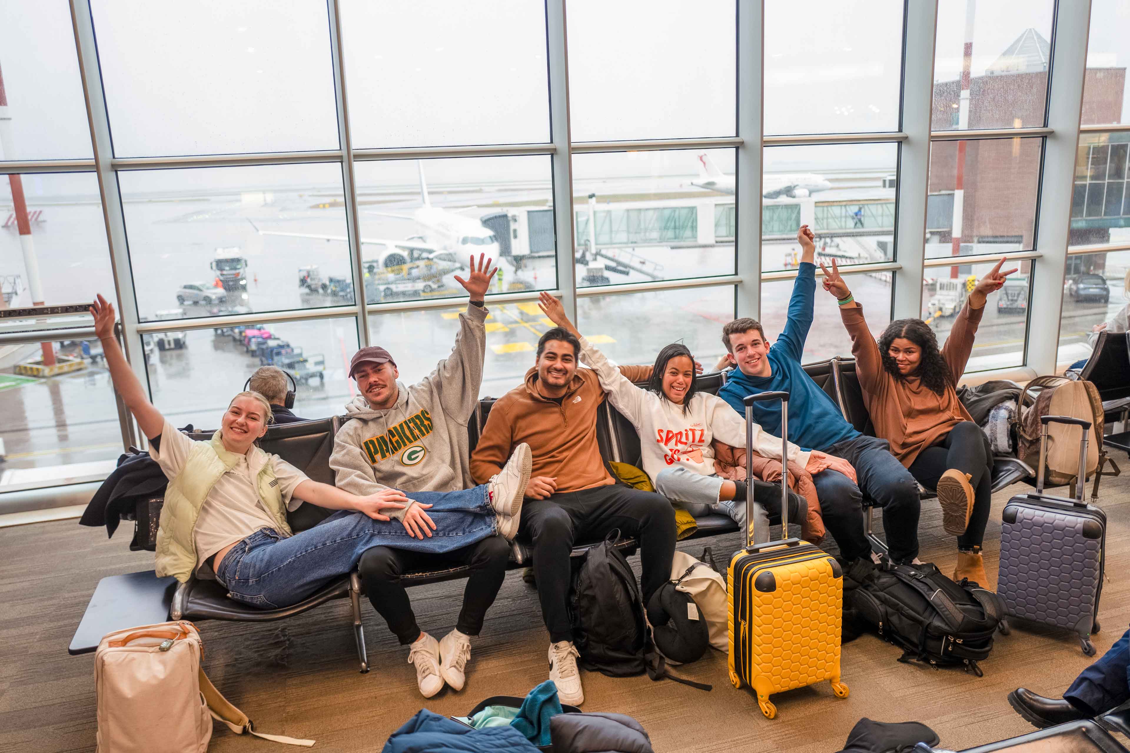 Group Of Young Travelers Waiting In Airport