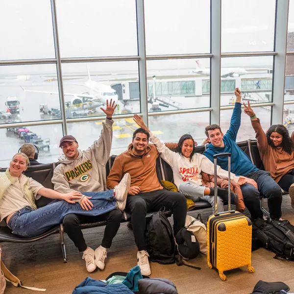 Group Of Young Travelers Waiting In Airport