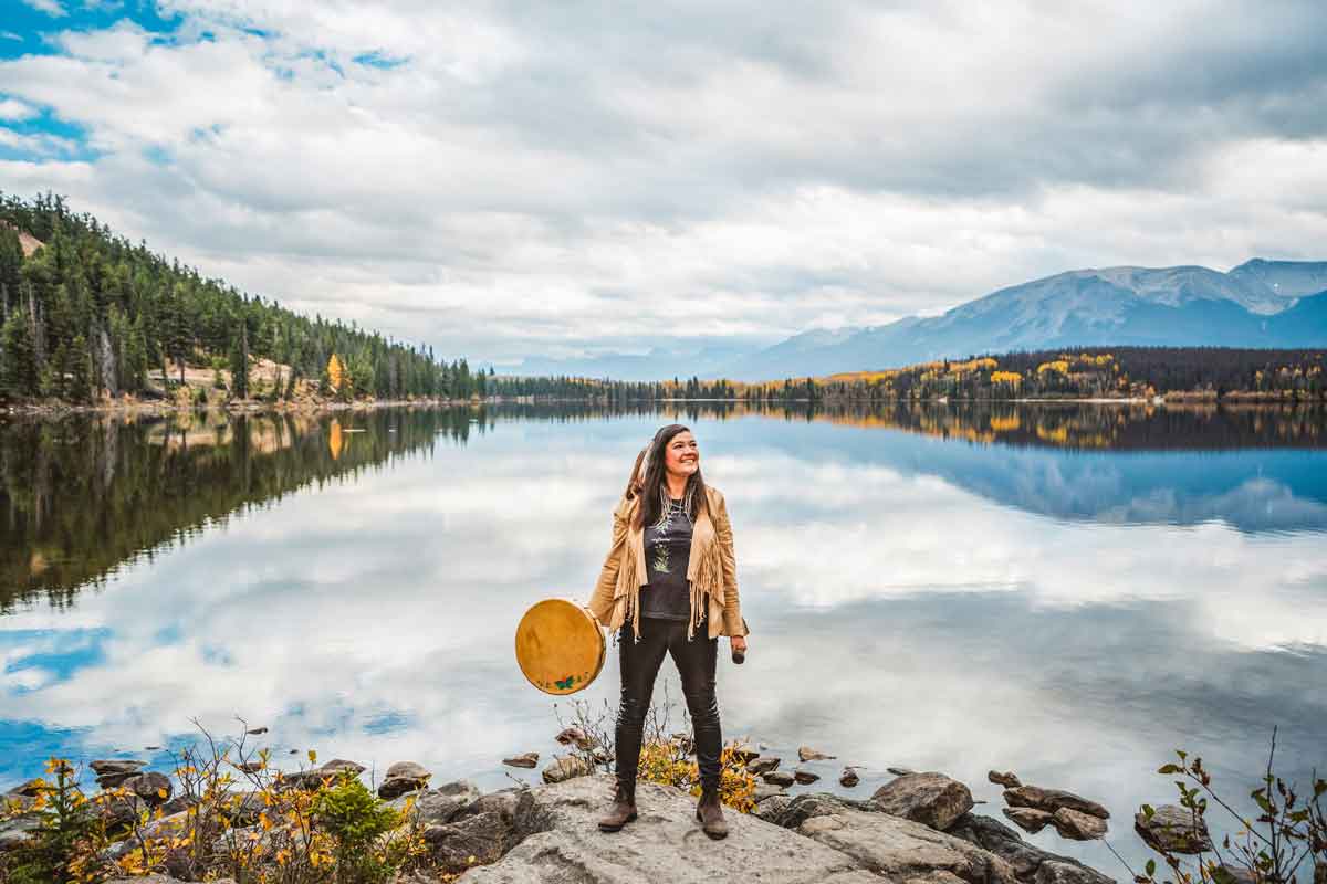 Woman Standing On Edge Of Lake In America Usa