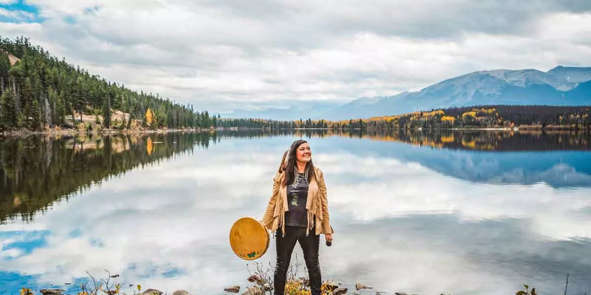 Woman Standing On Edge Of Lake In America Usa
