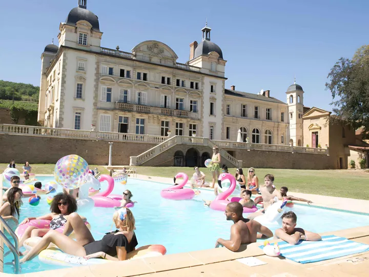 Friends In Swimming Pool Enjoying Sunny Day