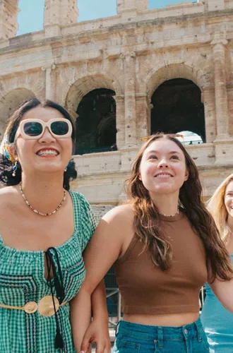 Travellers walking past the Colosseum in Rome, Italy - Contiki Rome, Athens & Cairo Tour