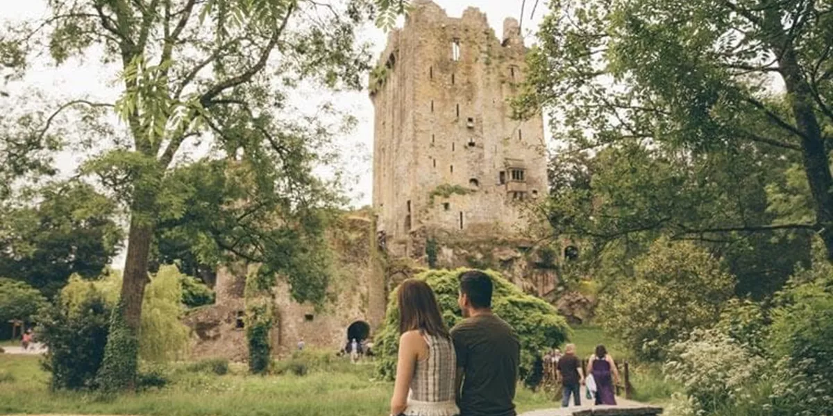 Travelers watching Blarney Castle in Cork, Ireland