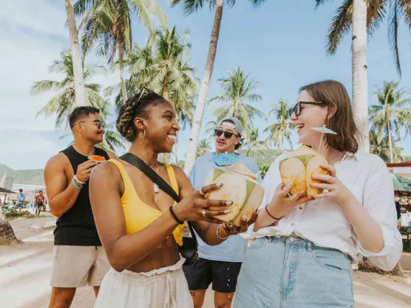 Friends Talking And Drinking Coconut