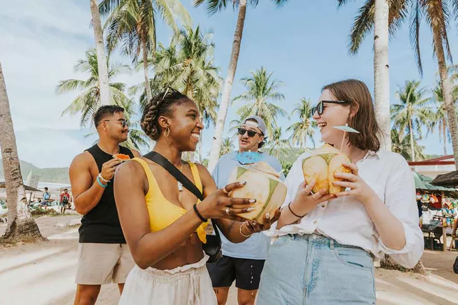 Friends Talking And Drinking Coconut