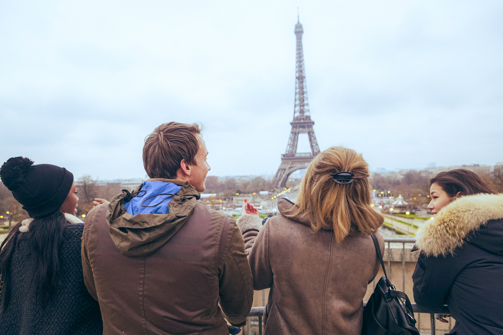 Travellers pose for a selfie in front of the Eiffel Tower, in Paris, France