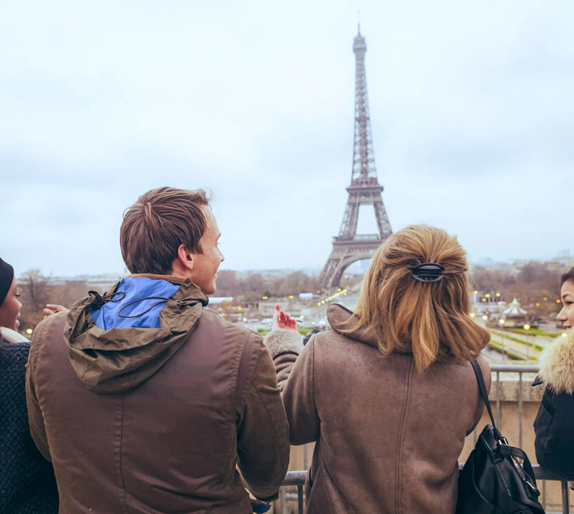 Travellers pose for a selfie in front of the Eiffel Tower, in Paris, France