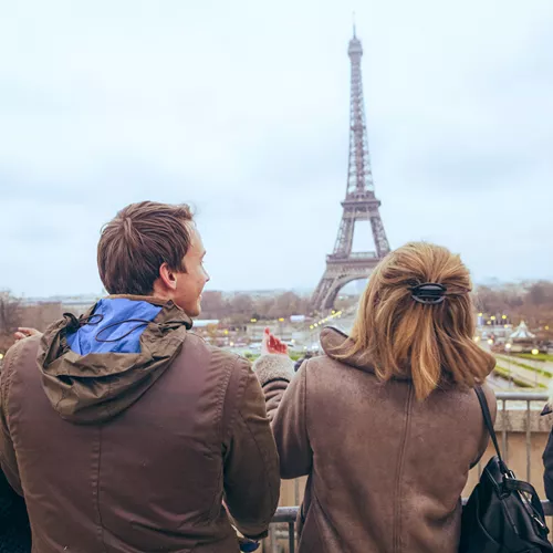 Travellers pose for a selfie in front of the Eiffel Tower, in Paris, France
