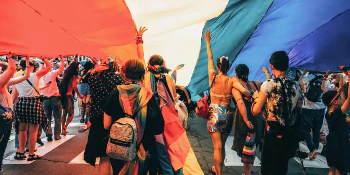 Group Having Fun Under Large Pride Flag