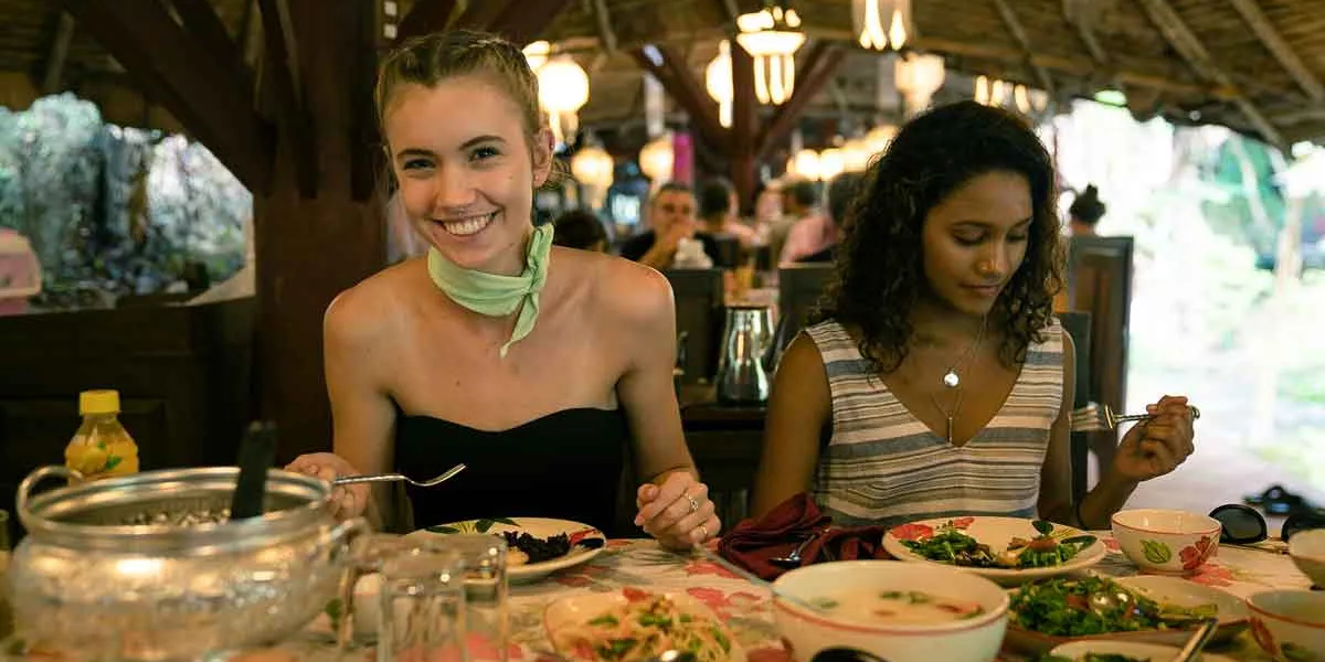 Two Young Women Enjoying A Meal