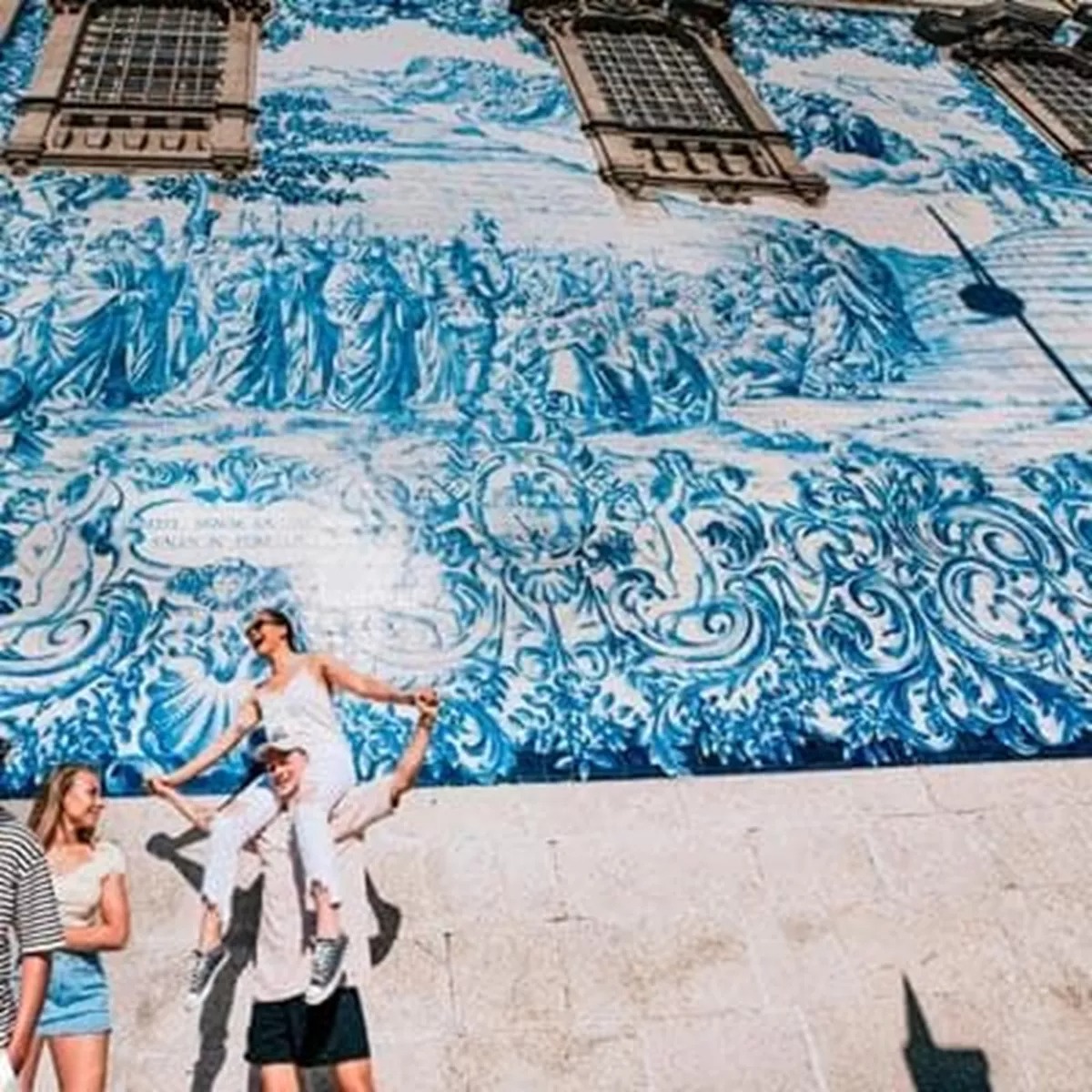 People having fun in front of the big mural