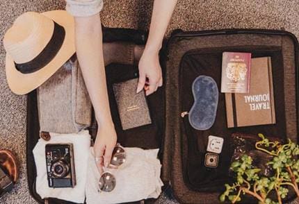A packed suitcase with travel essentials