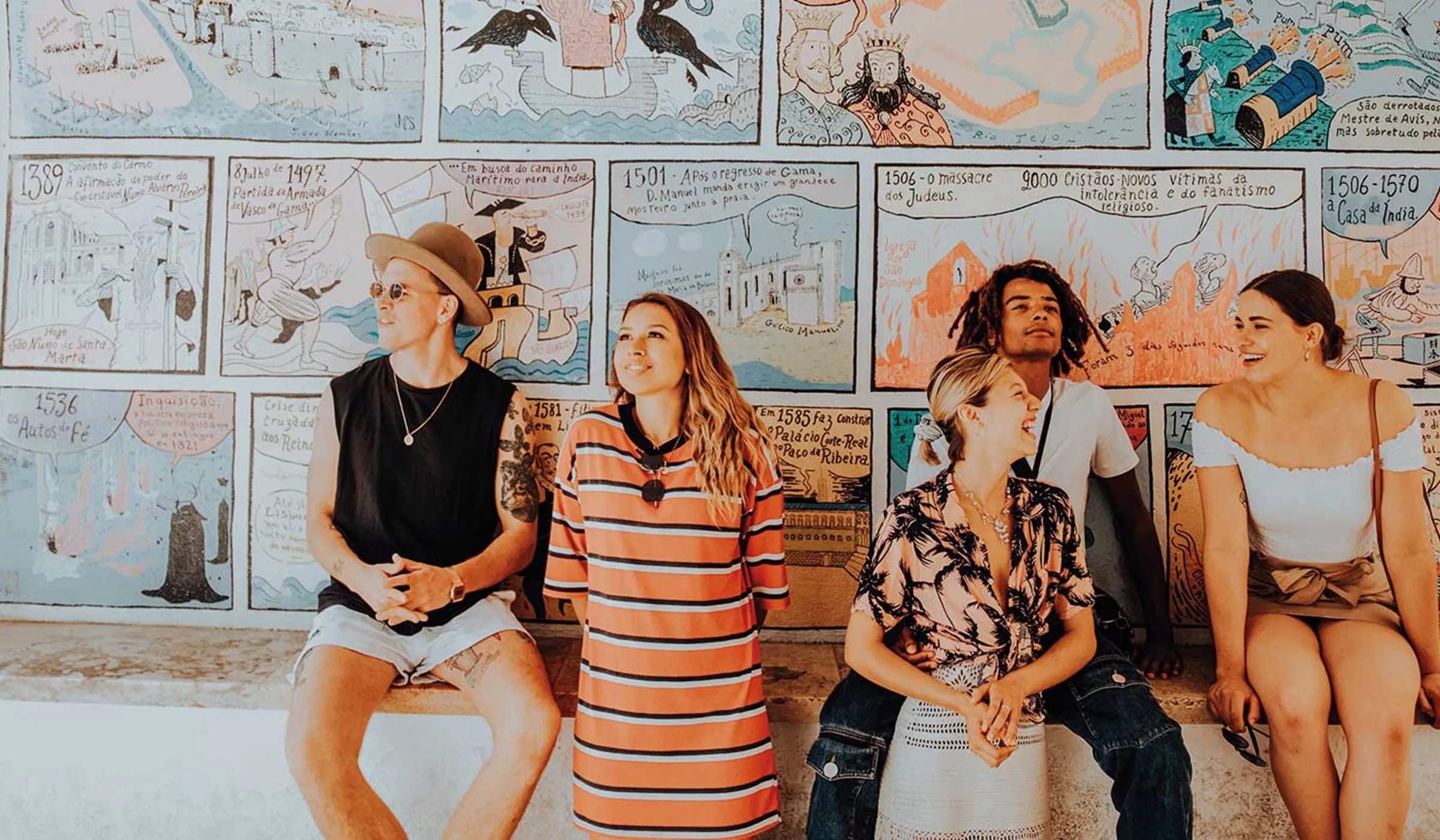 Group of people in front of wall with painted cartoons