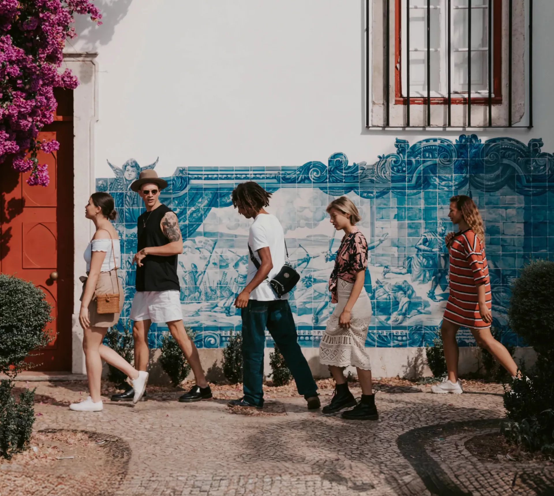 Travellers walking past traditional blue azulejo tiles in Lisbon, Portugal - Contiki Spain, Portugal & Morocco Uncovered Tour