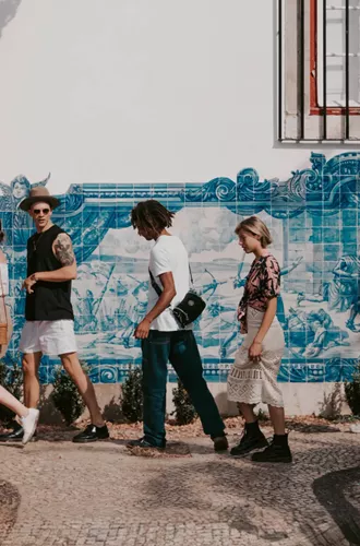 Travellers walking past traditional blue azulejo tiles in Lisbon, Portugal - Contiki Spain, Portugal & Morocco Uncovered Tour