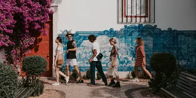 Travellers walking past traditional blue azulejo tiles in Lisbon, Portugal - Contiki Spain, Portugal & Morocco Uncovered Tour