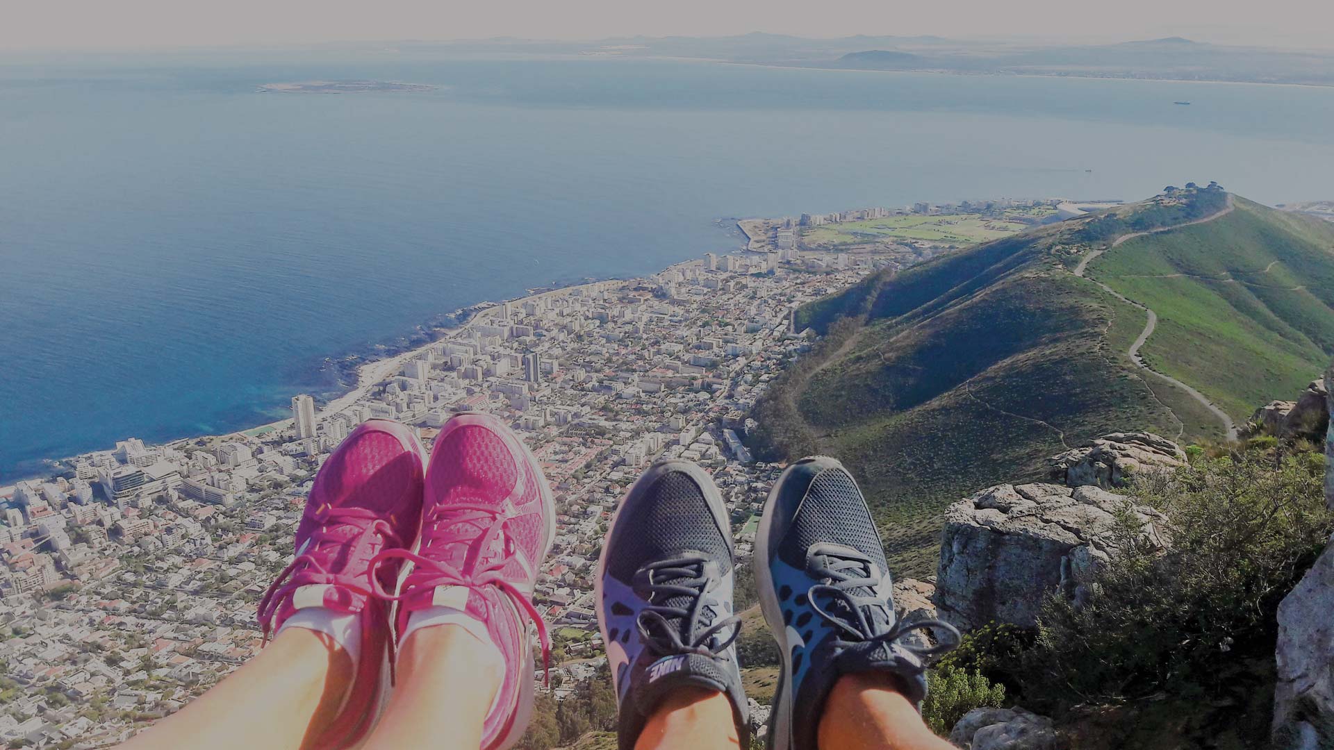 People with their feet up on the edge of a cliff