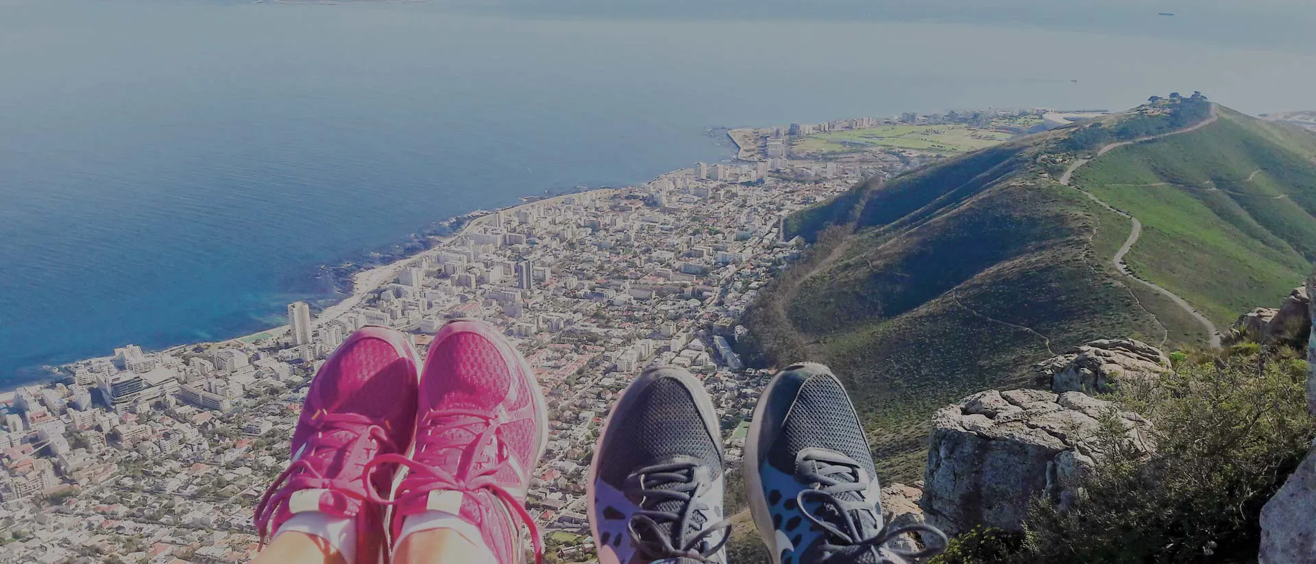 People with their feet up on the edge of a cliff