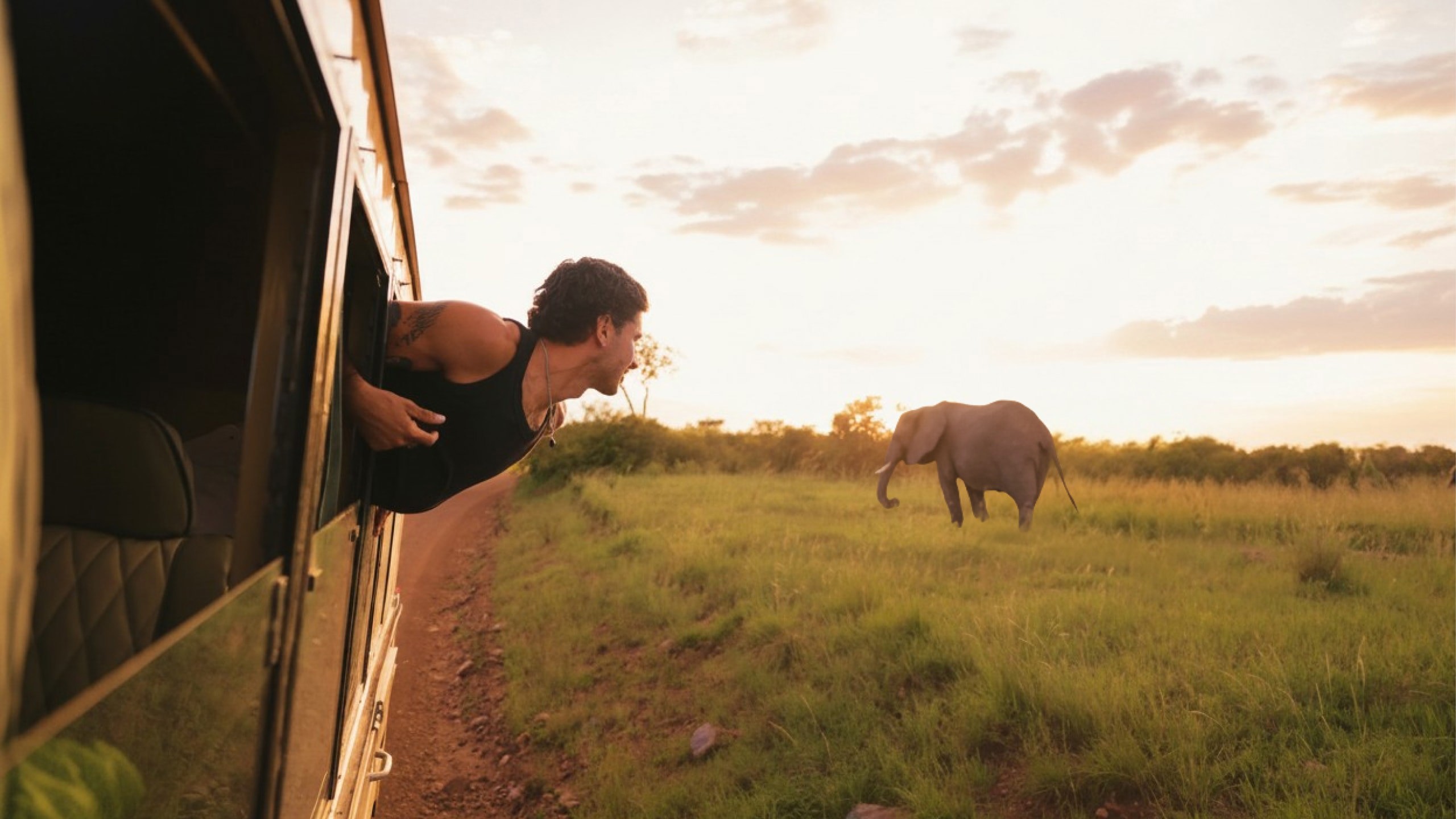 Contiki traveller spotting an elephant on safari - Contiki Best of Uganda & Kenya Tour
