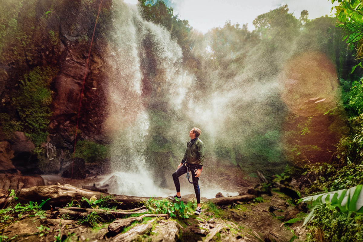 Man Looking At Waterfall