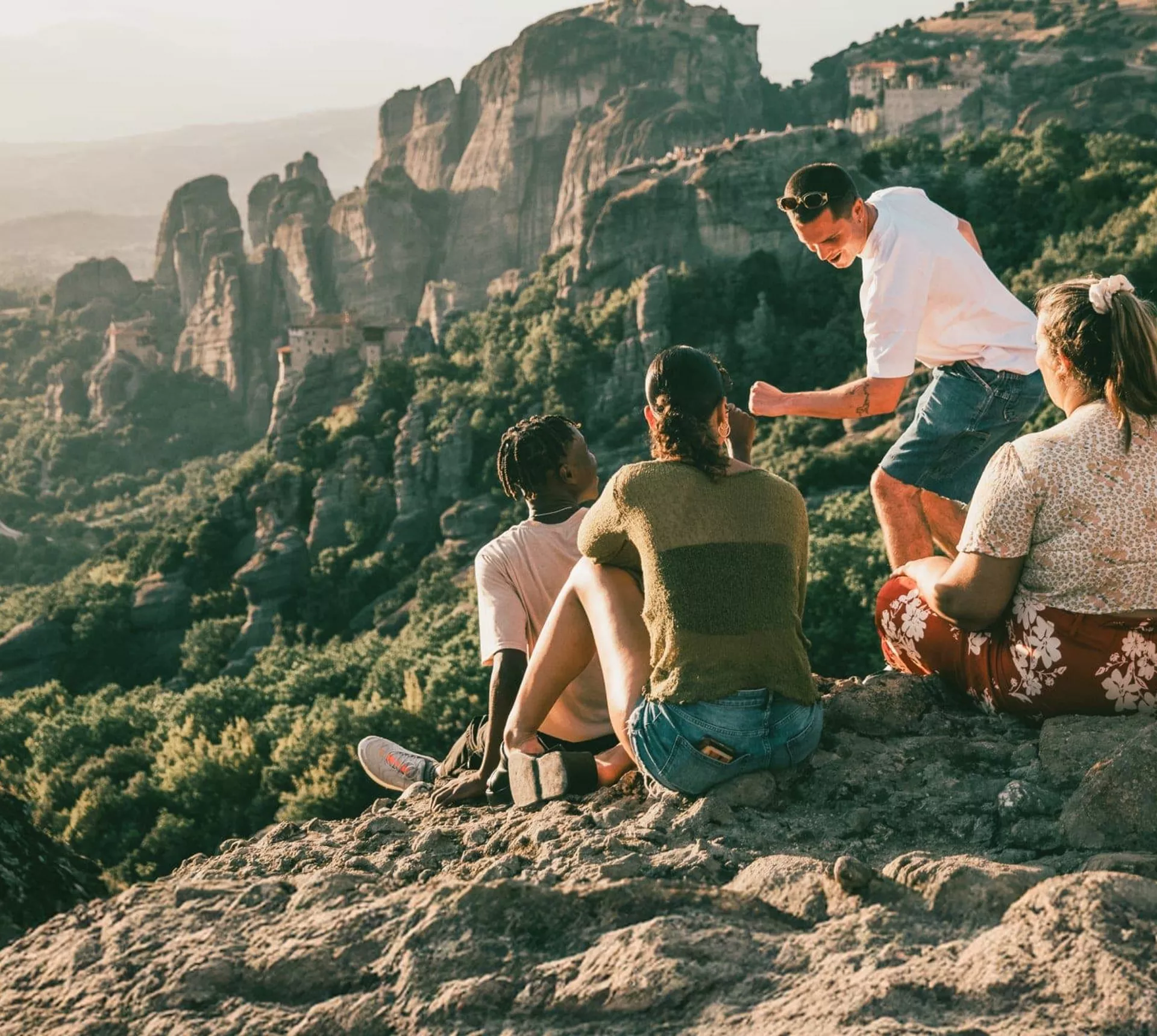 Travellers take in panoramic views of Meteora's cliff-top monasteries during Contiki's Greece: Athens, Delphi & Meteora Tour
