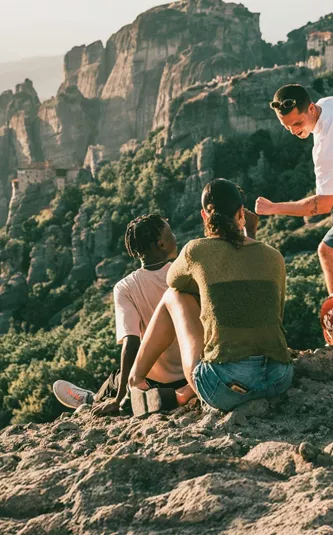 Travellers take in panoramic views of Meteora's cliff-top monasteries during Contiki's Greece: Athens, Delphi & Meteora Tour