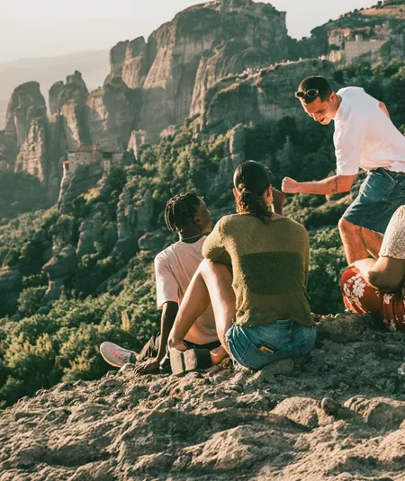 Travellers take in panoramic views of Meteora's cliff-top monasteries during Contiki's Greece: Athens, Delphi & Meteora Tour