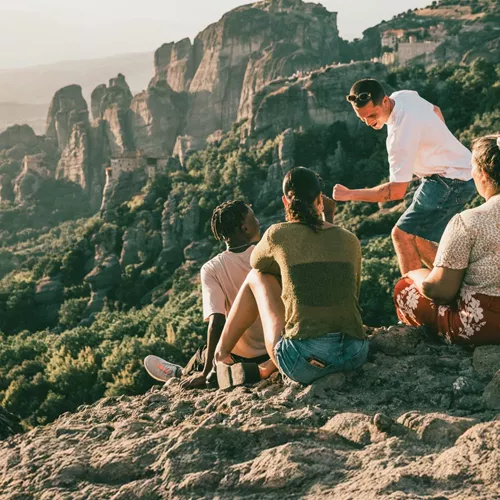 Travellers take in panoramic views of Meteora's cliff-top monasteries during Contiki's Greece: Athens, Delphi & Meteora Tour