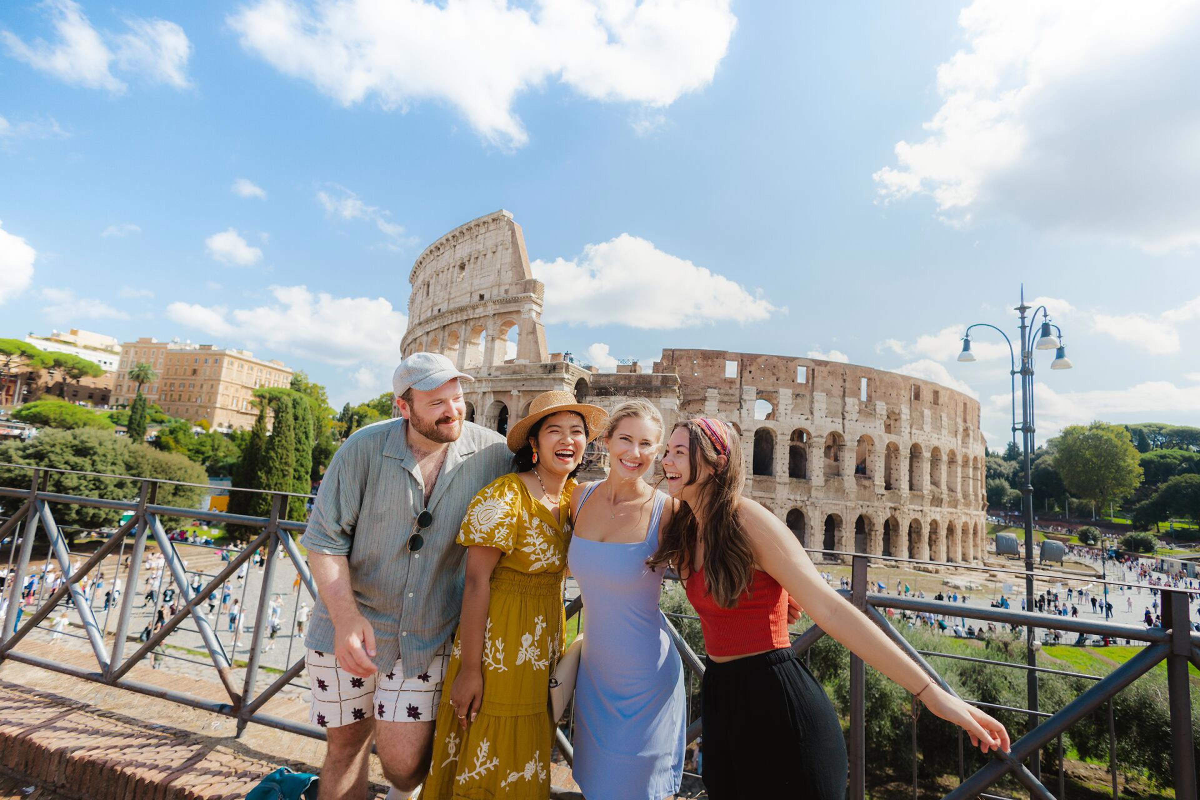 Four Friends Smiling Rome Landmark Building At The Back