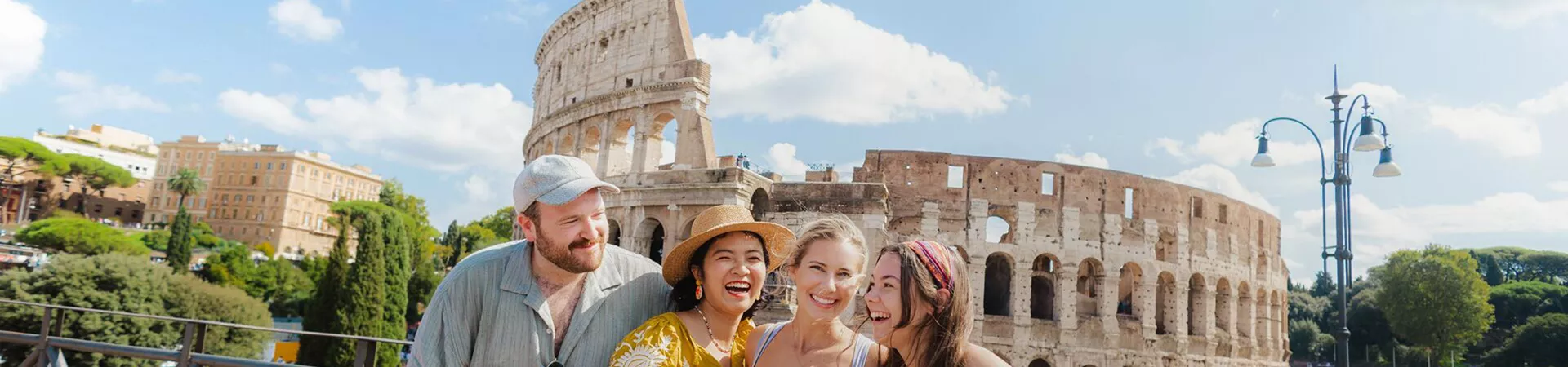 Four Friends Smiling Rome Landmark Building At The Back