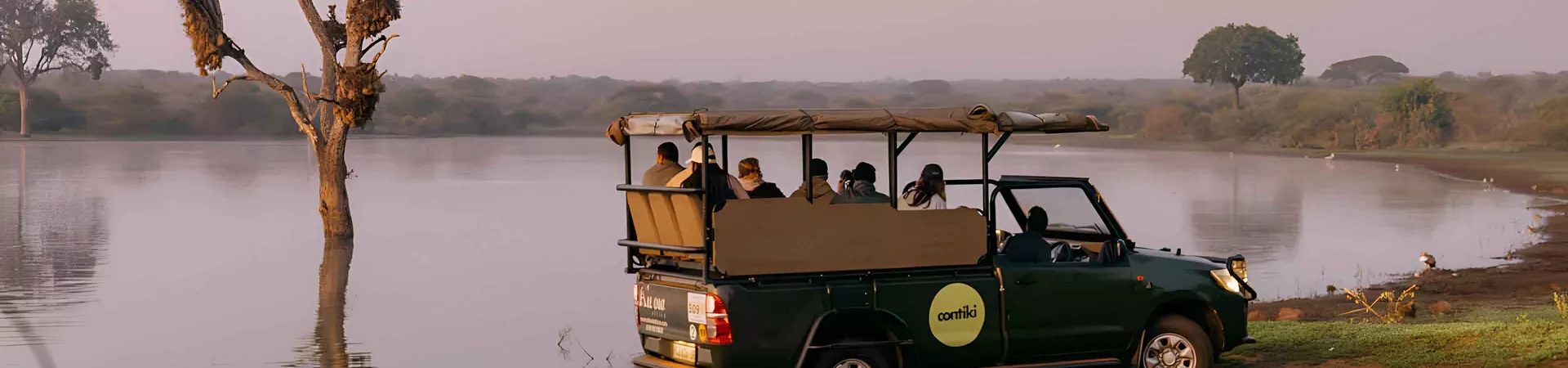 Safari Truck Driving Close To Lake