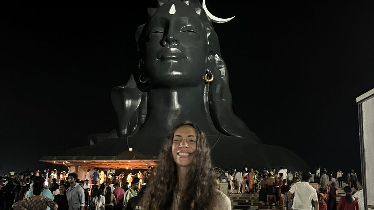 Woman Standing In Front Of Statue
